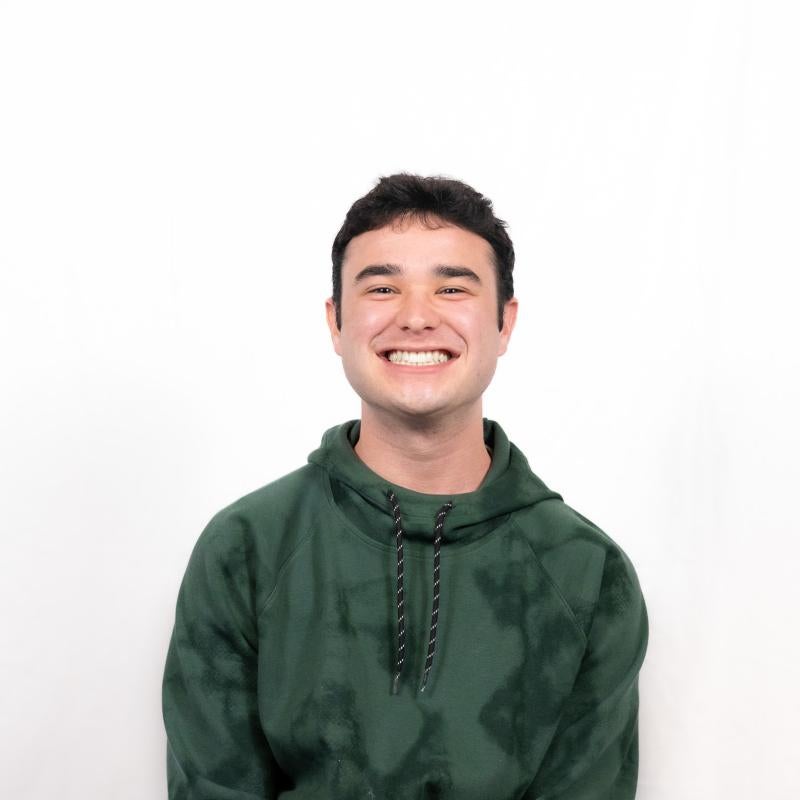 Headshot of Jacob Mora smiling with white background